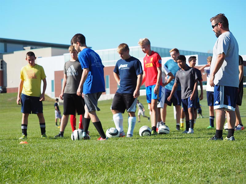 Manistee Chippewas Boys Soccer Team Photo on field at practice working on drills