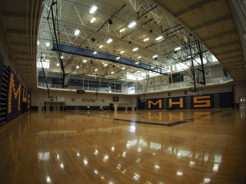MMHS gym floor with a couple people playing in the distance