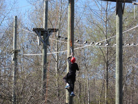 Student climbing pole