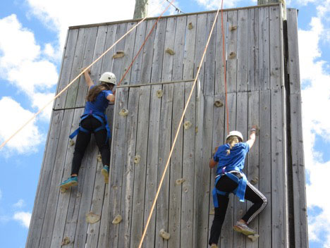 Students climbing wall