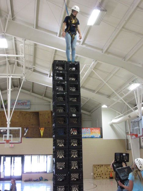 Student climbing crates
