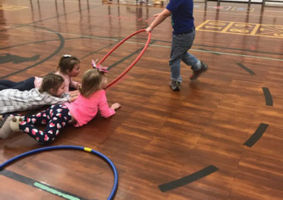 Students playing with hula hoops