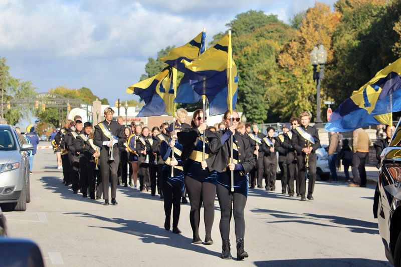 Students in band marching in parade