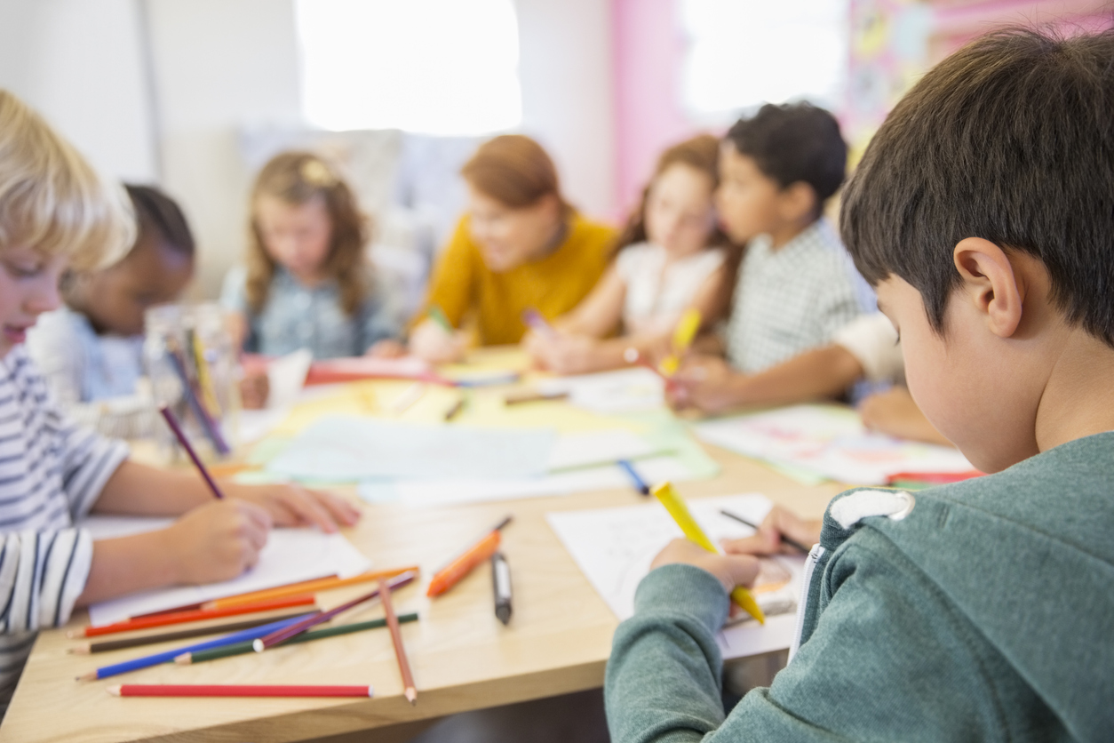 Teacher And Students Drawing In Classroom small children in a classroom