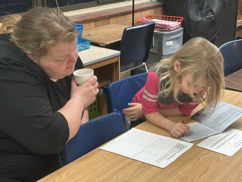 Family member with student at books and breakfast event