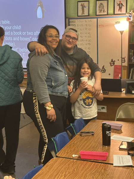 Family members with students at books and breakfast event